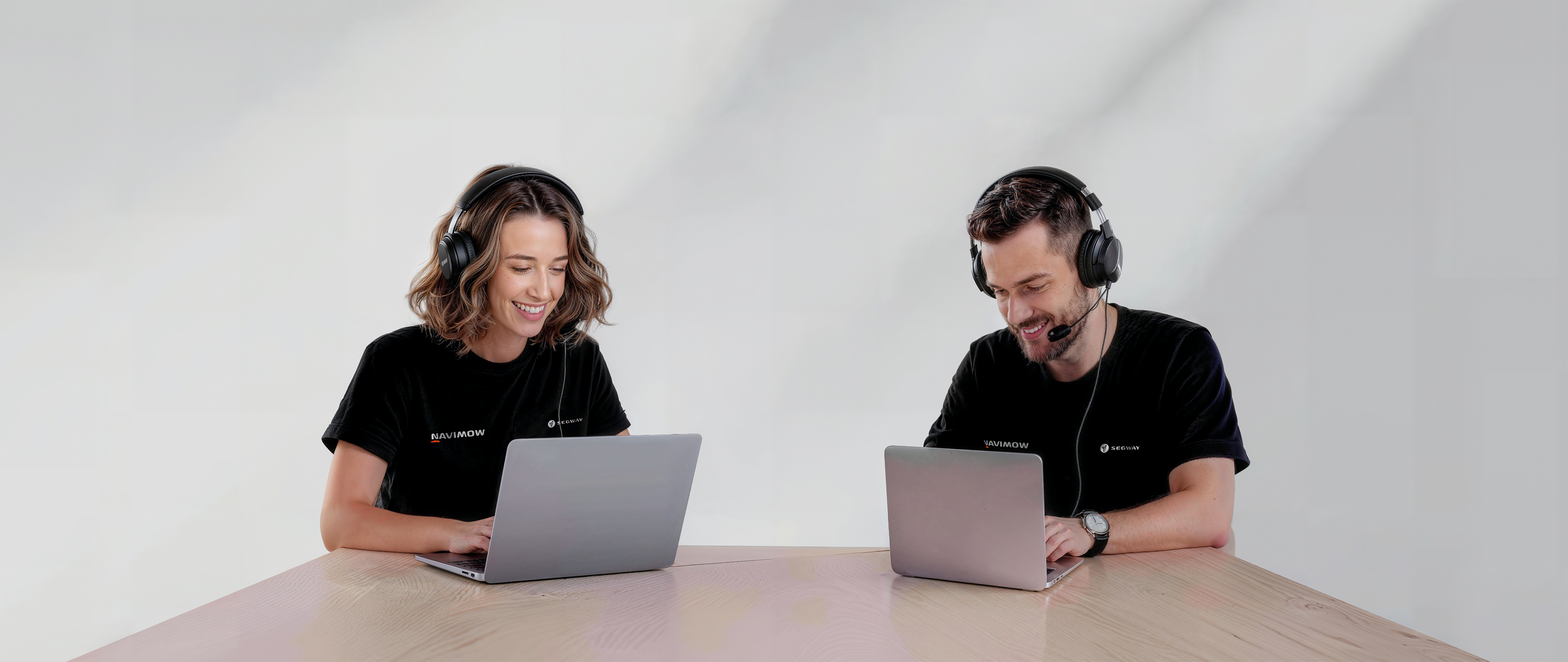 Navimow i110N robot lawn mower customer support team using laptops.