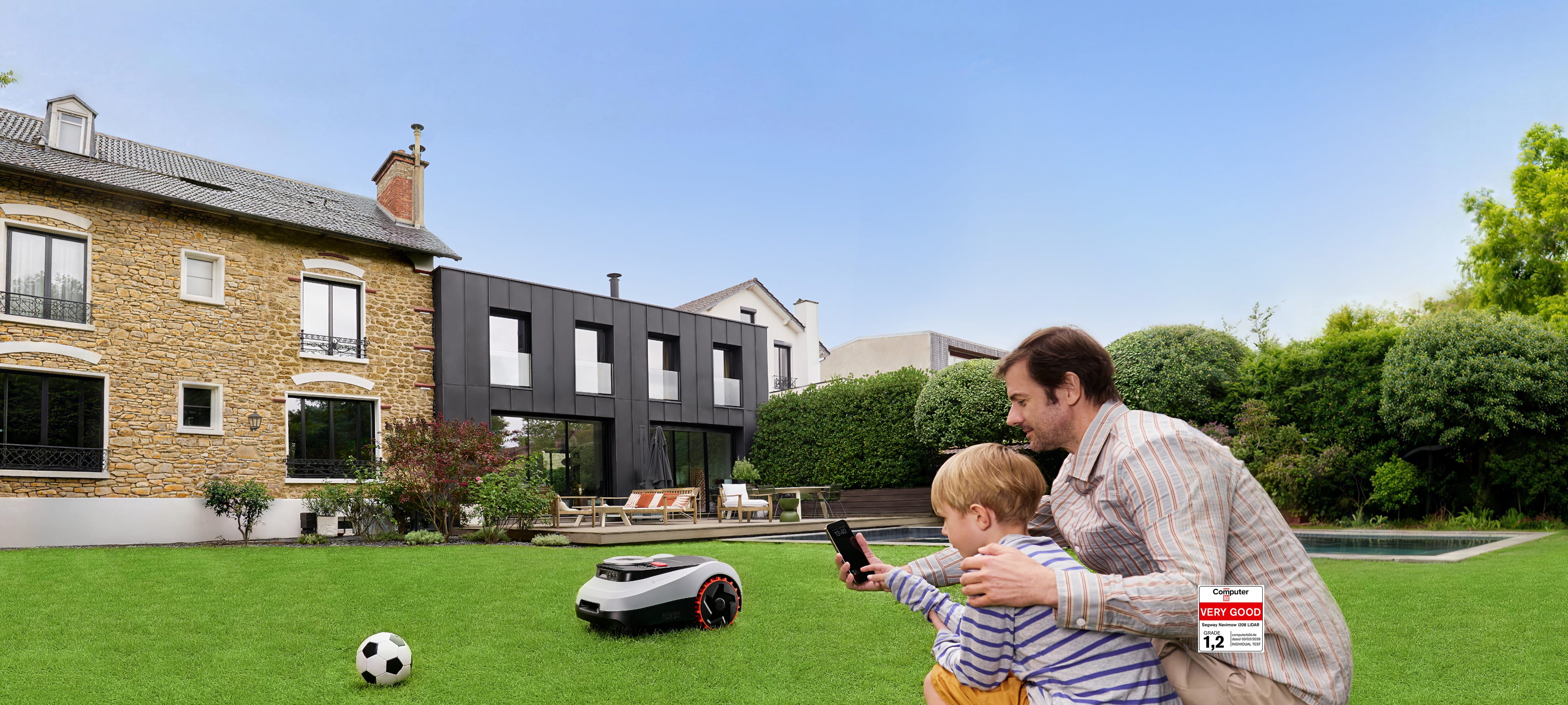 Segway Navimow i2 LiDAR robot lawn mower on lawn by a soccer ball and family with phone