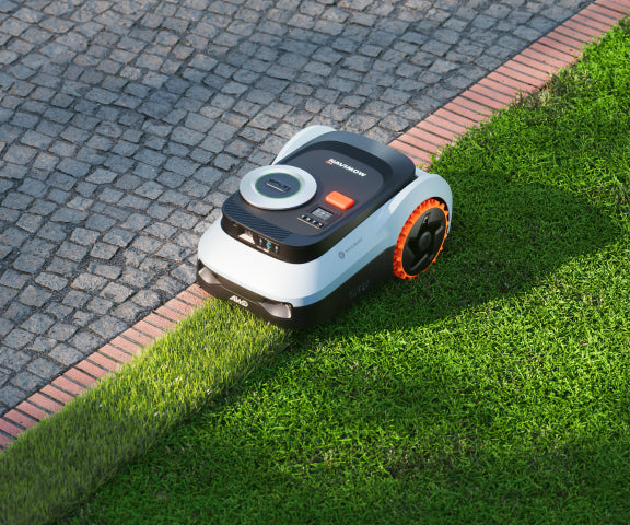 Navimow i110E robot lawn mower is mowing the green grass.