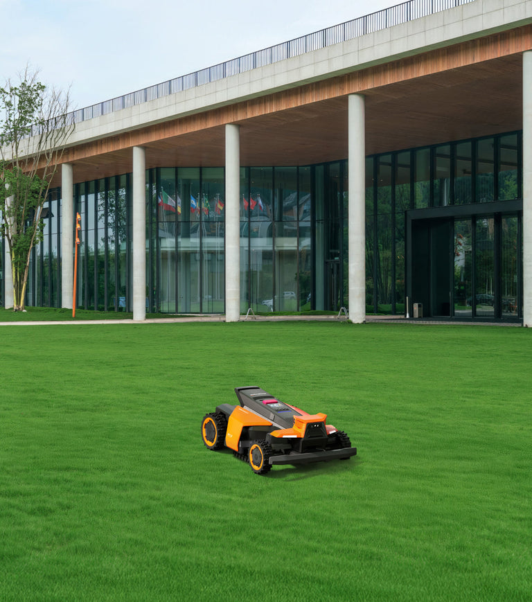 Navimow i110N robot lawn mower on a bright green lawn.