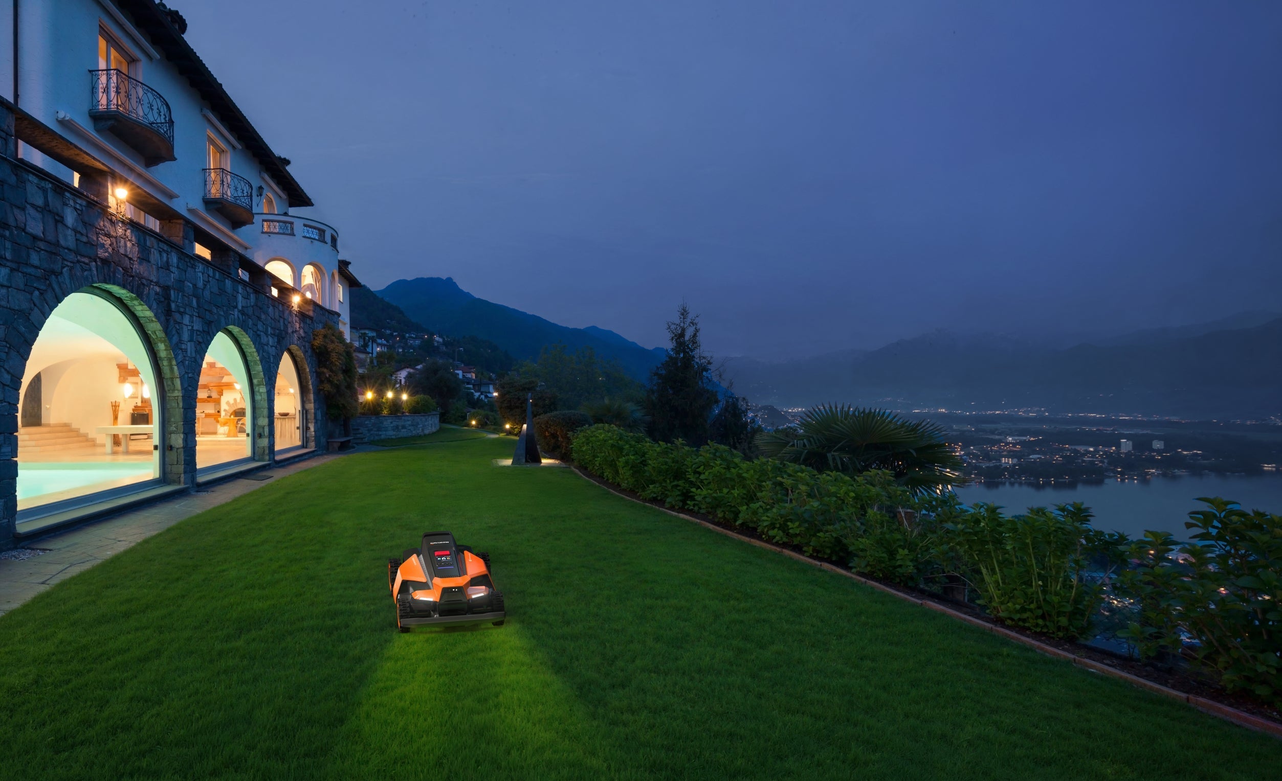 Navimow i105E robot lawn mower mows the lawn at night.