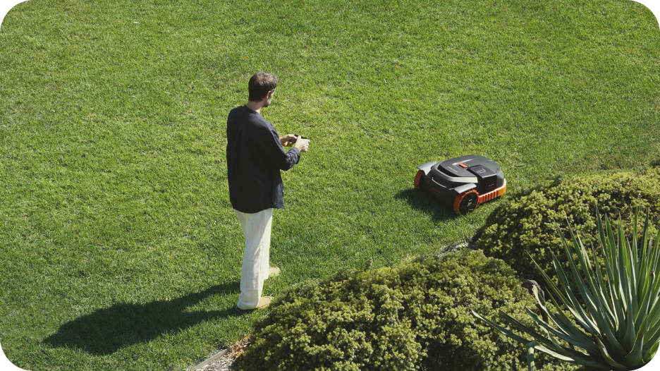 Segway Navimow i110N robot lawn mower in a green field.