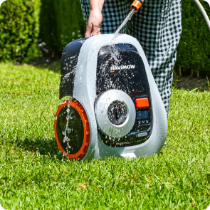 Navimow i110N robot lawn mower is being washed with water.