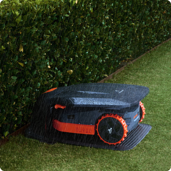Navimow i110E robot lawn mower parked in rain under cover.