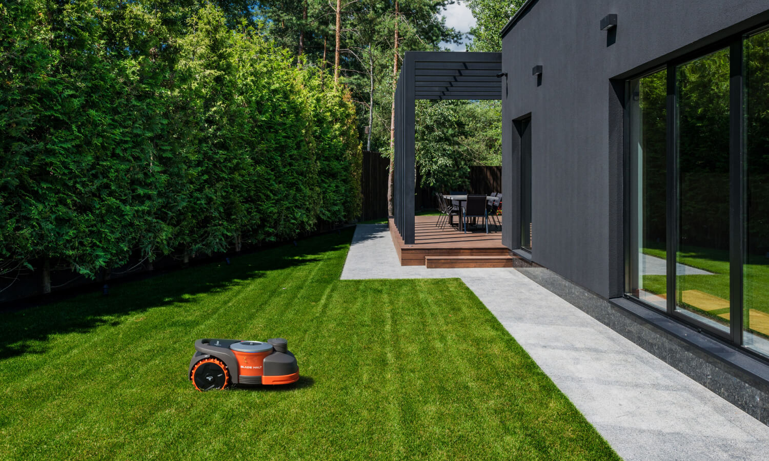 Segway Navimow i110N robot lawn mower on the backyard grass.