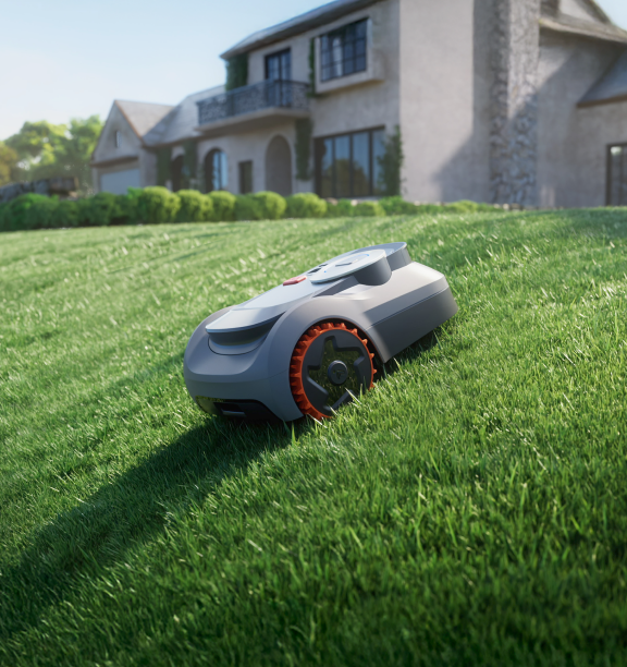 Navimow i110 robot lawn mower on a steep green lawn.