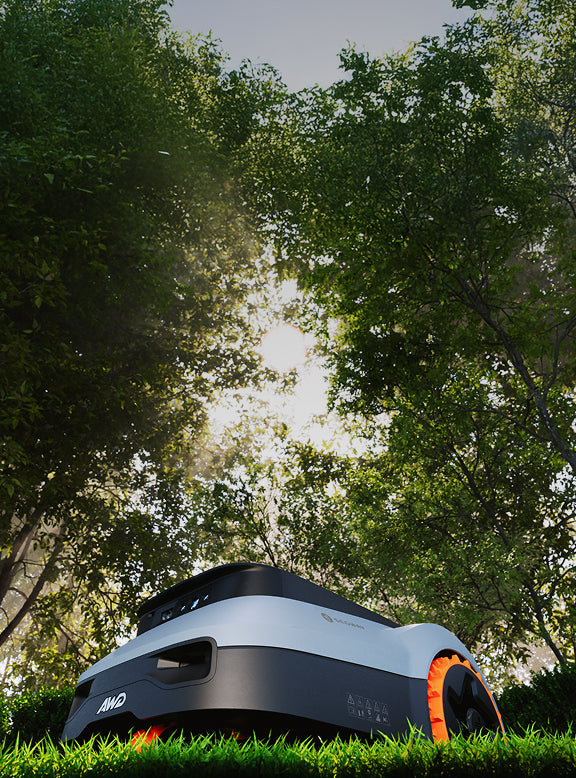 Segway Navimow H3000E robot lawn mower sits on green grass.