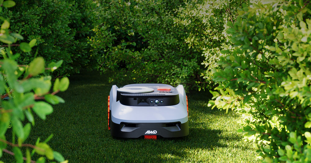 Navimow i110N AWD robot lawn mower on a green lawn.