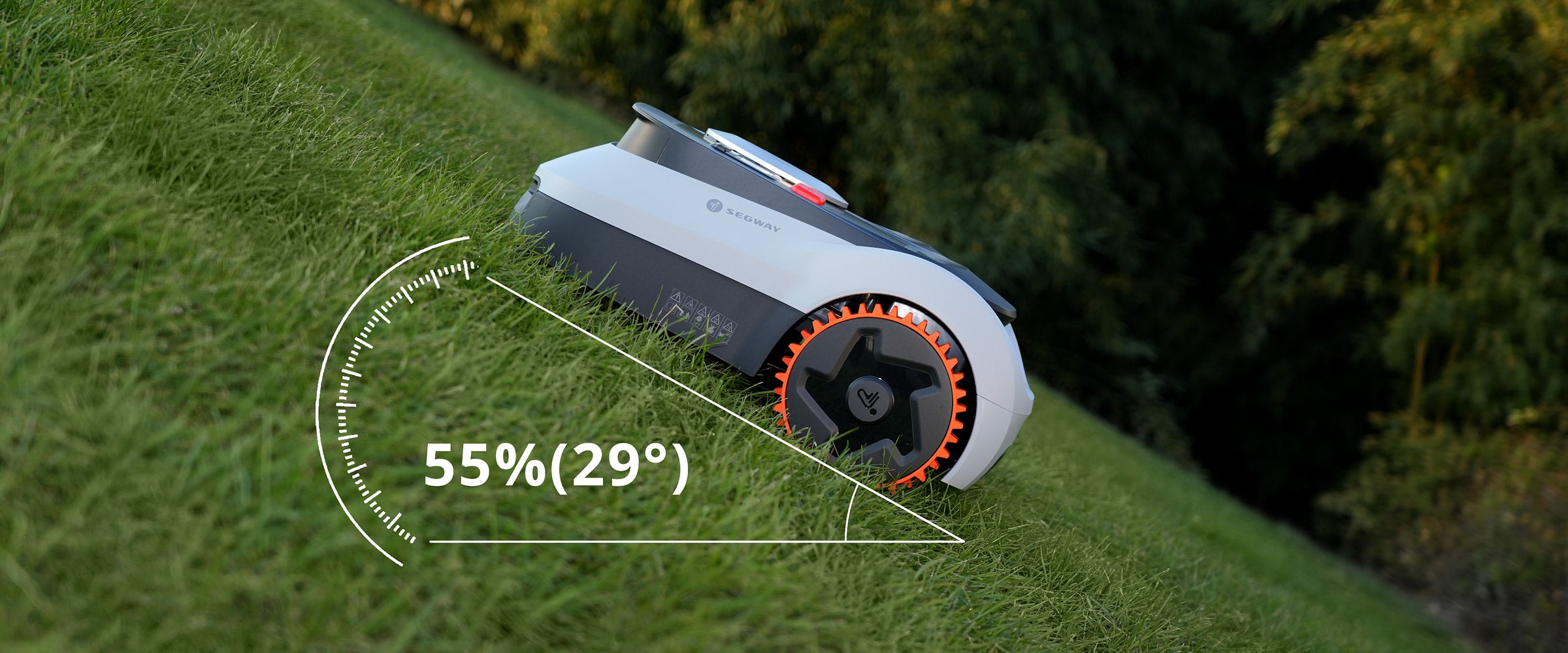 Segway Navimow robot lawn mower on a steep grassy slope.