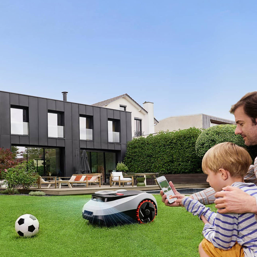 Navimow i105E robot lawn mower being used in the backyard.